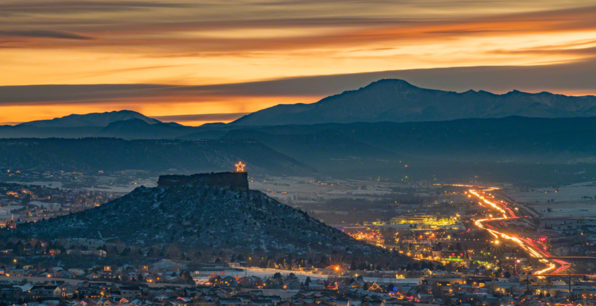The Castle Rock at dusk, lit star above downtown